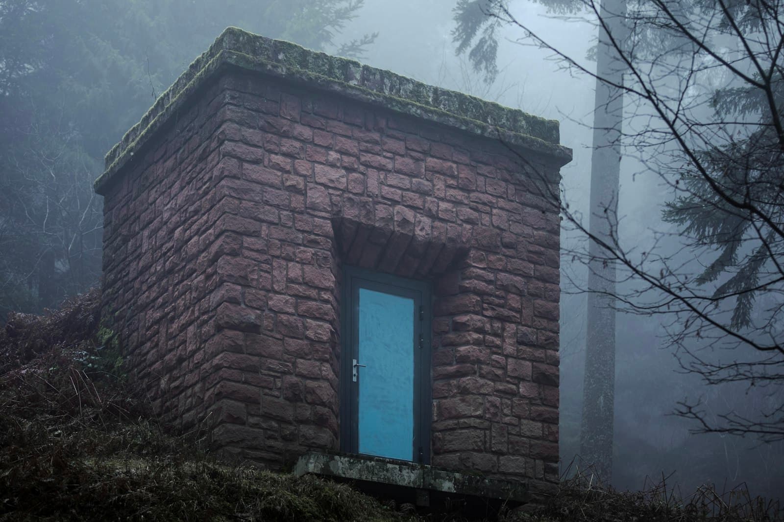 Wangenbourg — Stone building with blue door in foggy forest