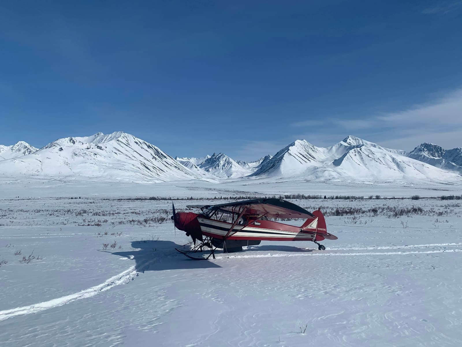 Wasilla — red and black boat on snow covered ground during daytime