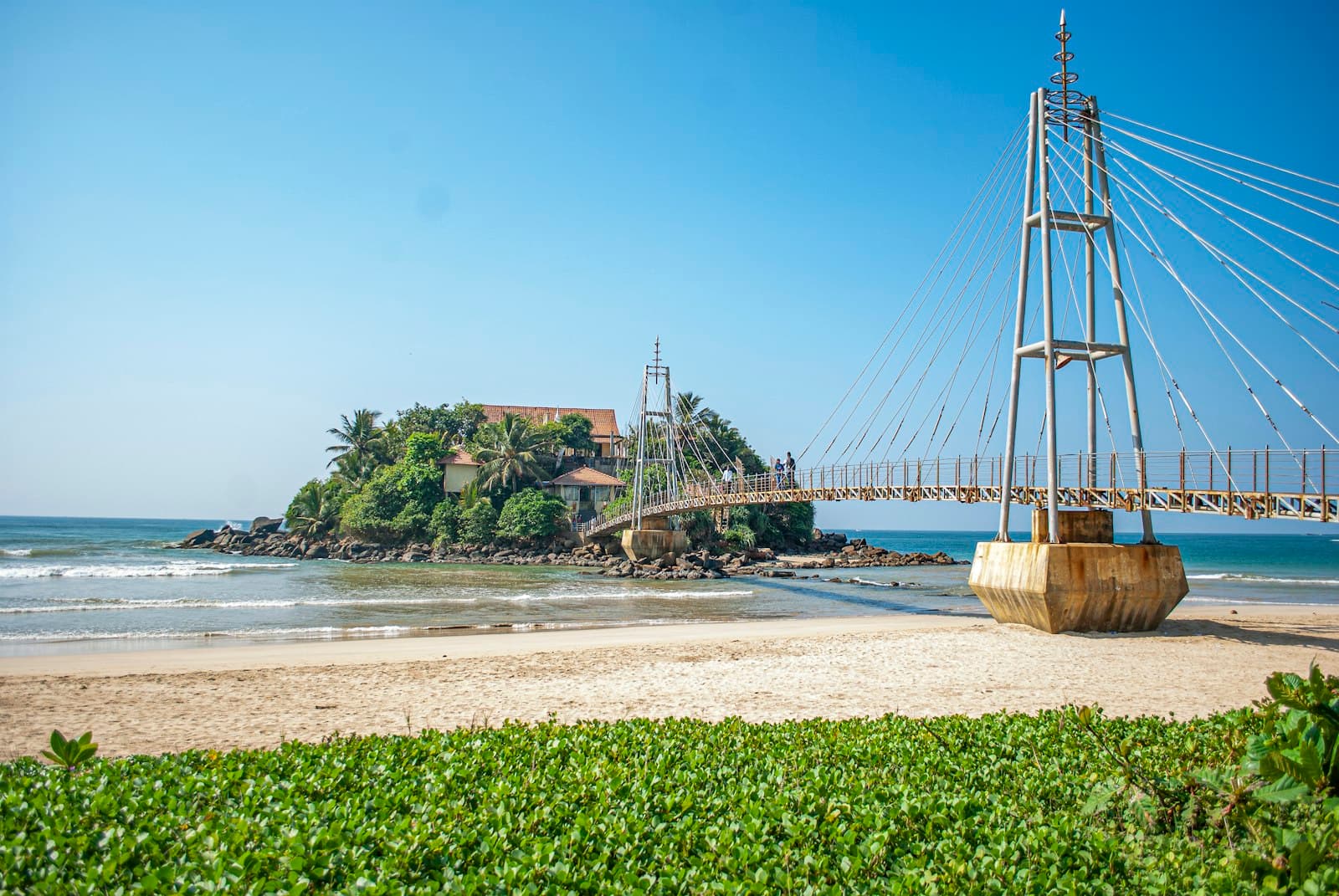 Weligama — brown wooden bridge over the sea during daytime