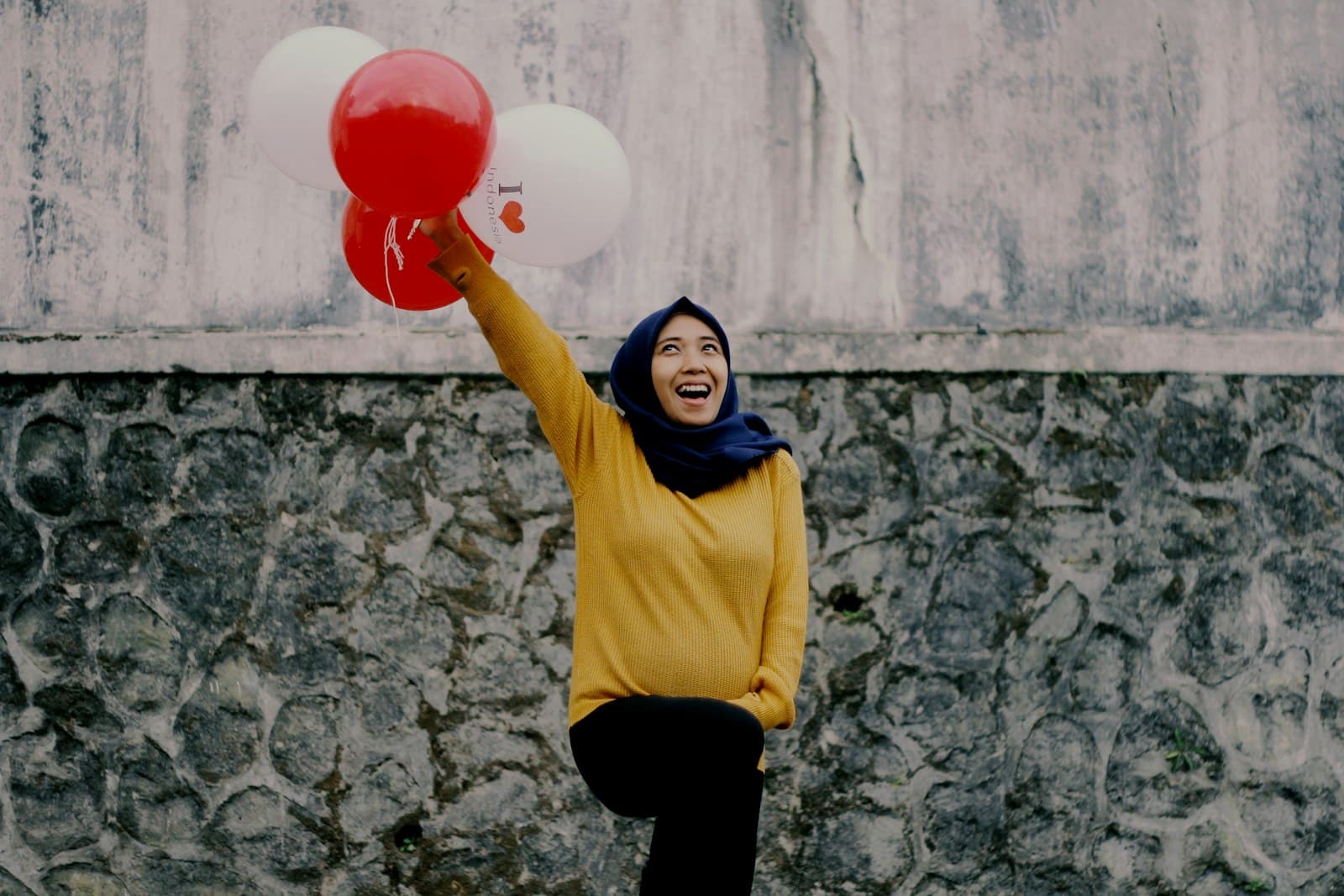 Wonosobo — woman in yellow long sleeve shirt holding red balloon