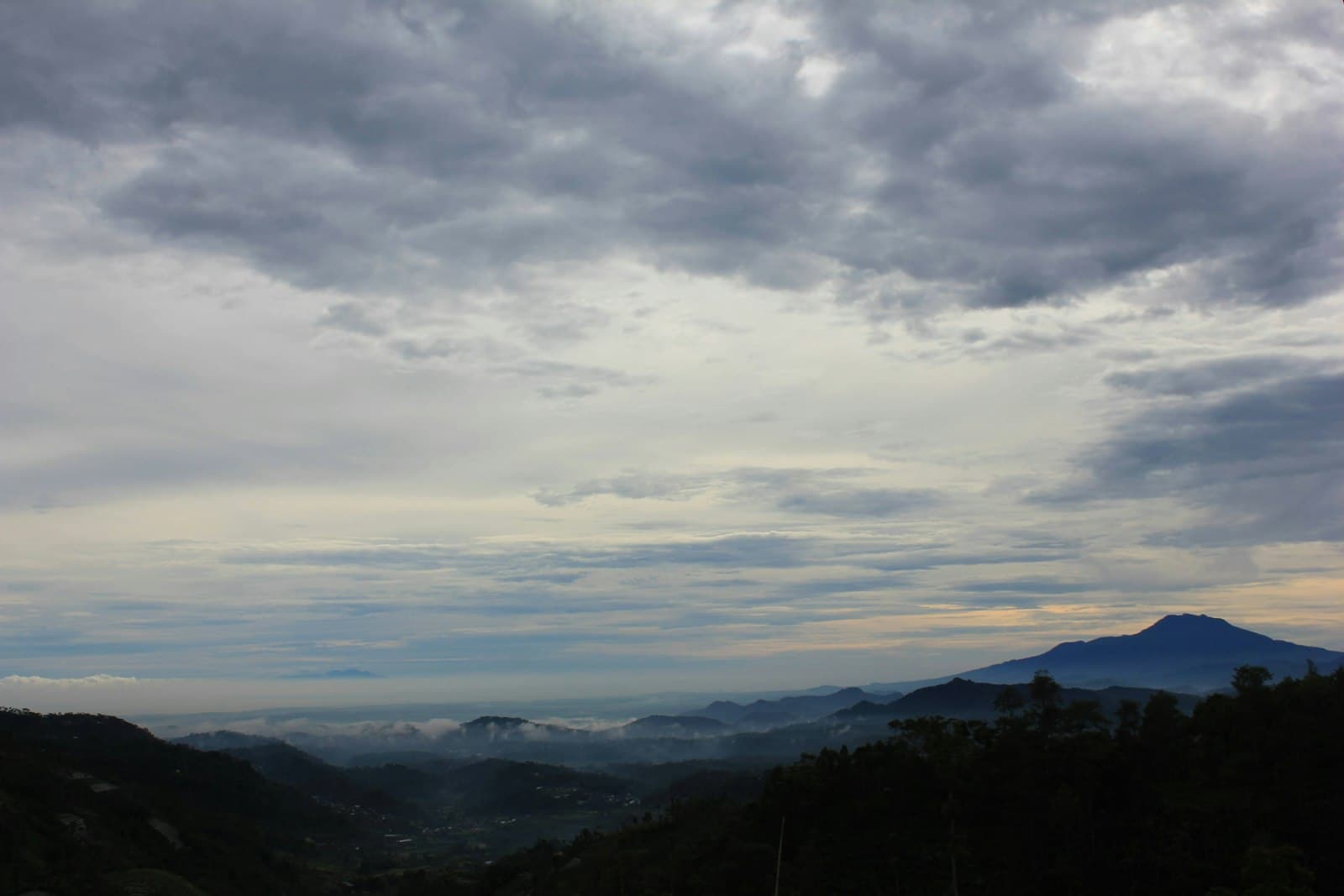 Wonosobo — a view of a mountain range with clouds in the sky