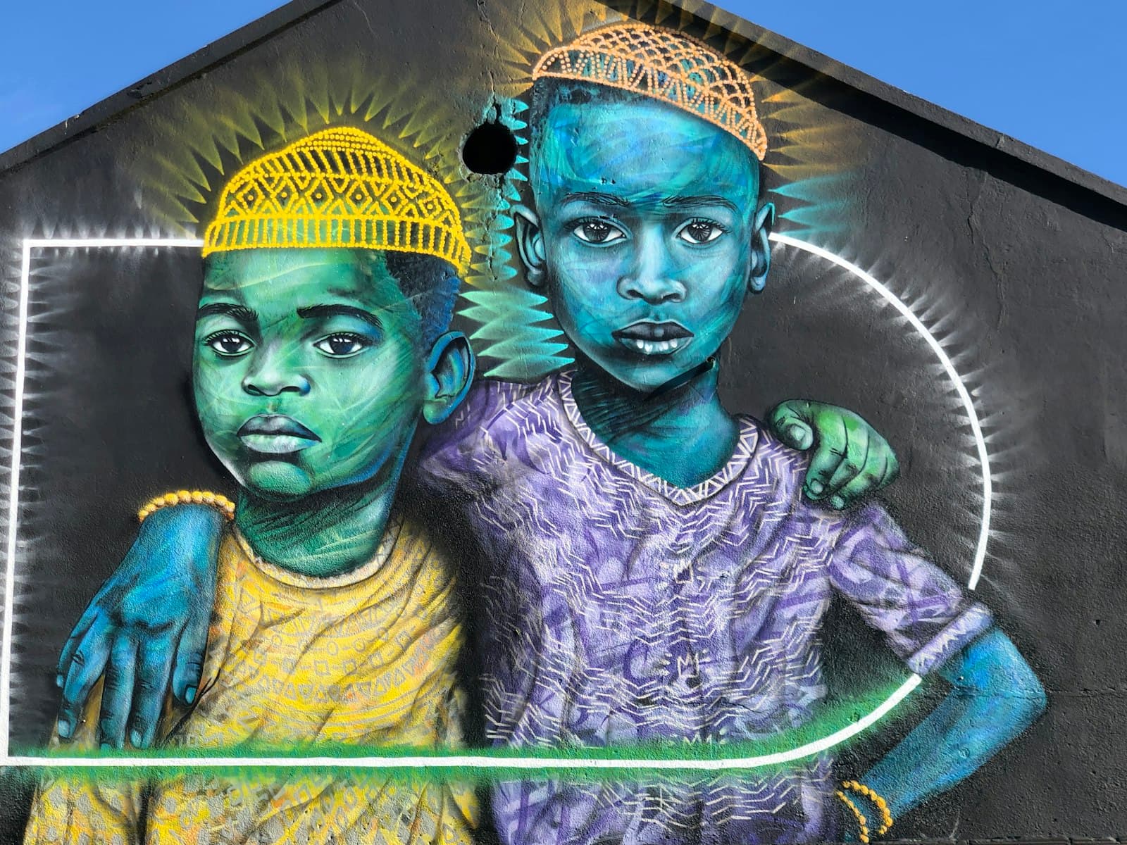 Woodstock Street Art — man in yellow and blue hat beside woman in yellow and green dress painting