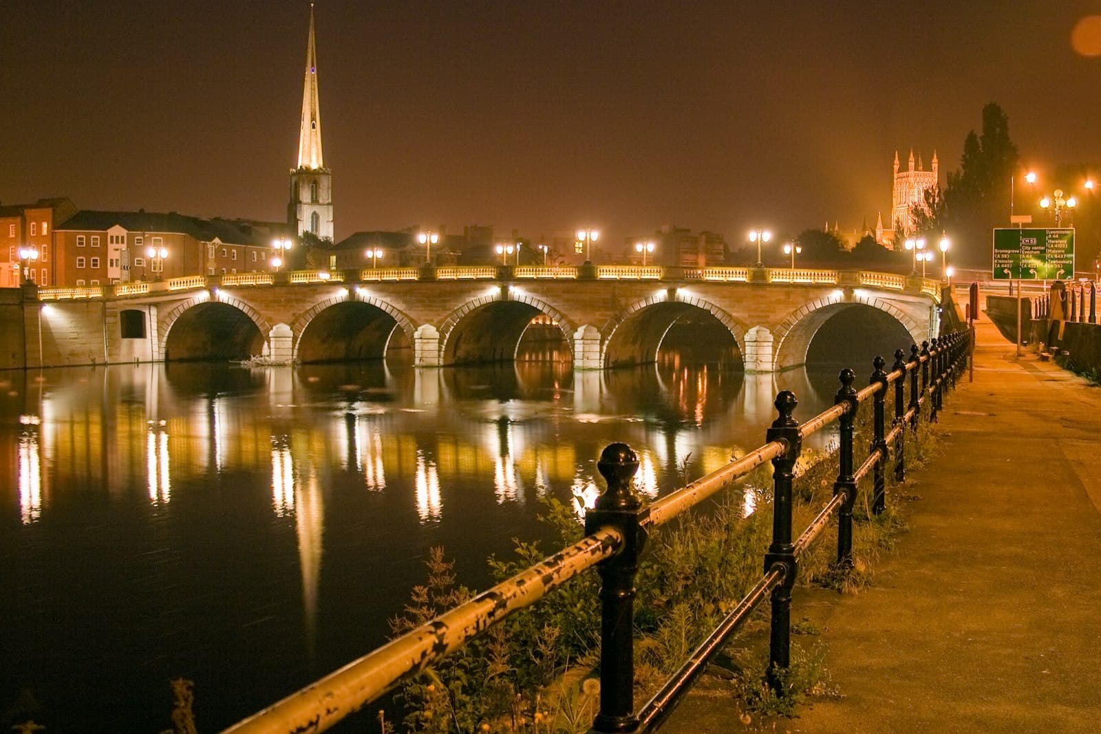Worcester — man and woman standing on bridge during night time