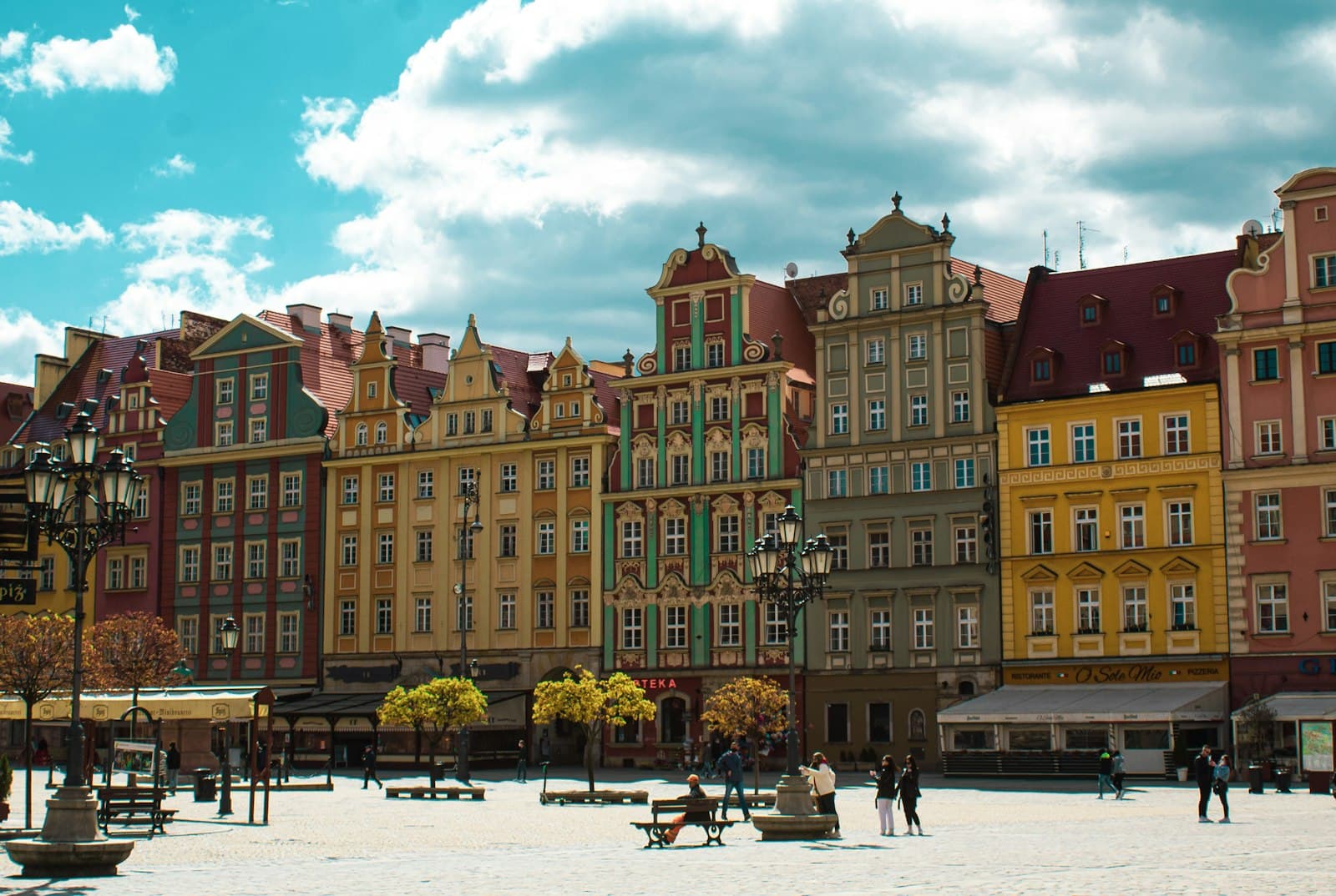 Wrocław — people walking on street near brown concrete building during daytime