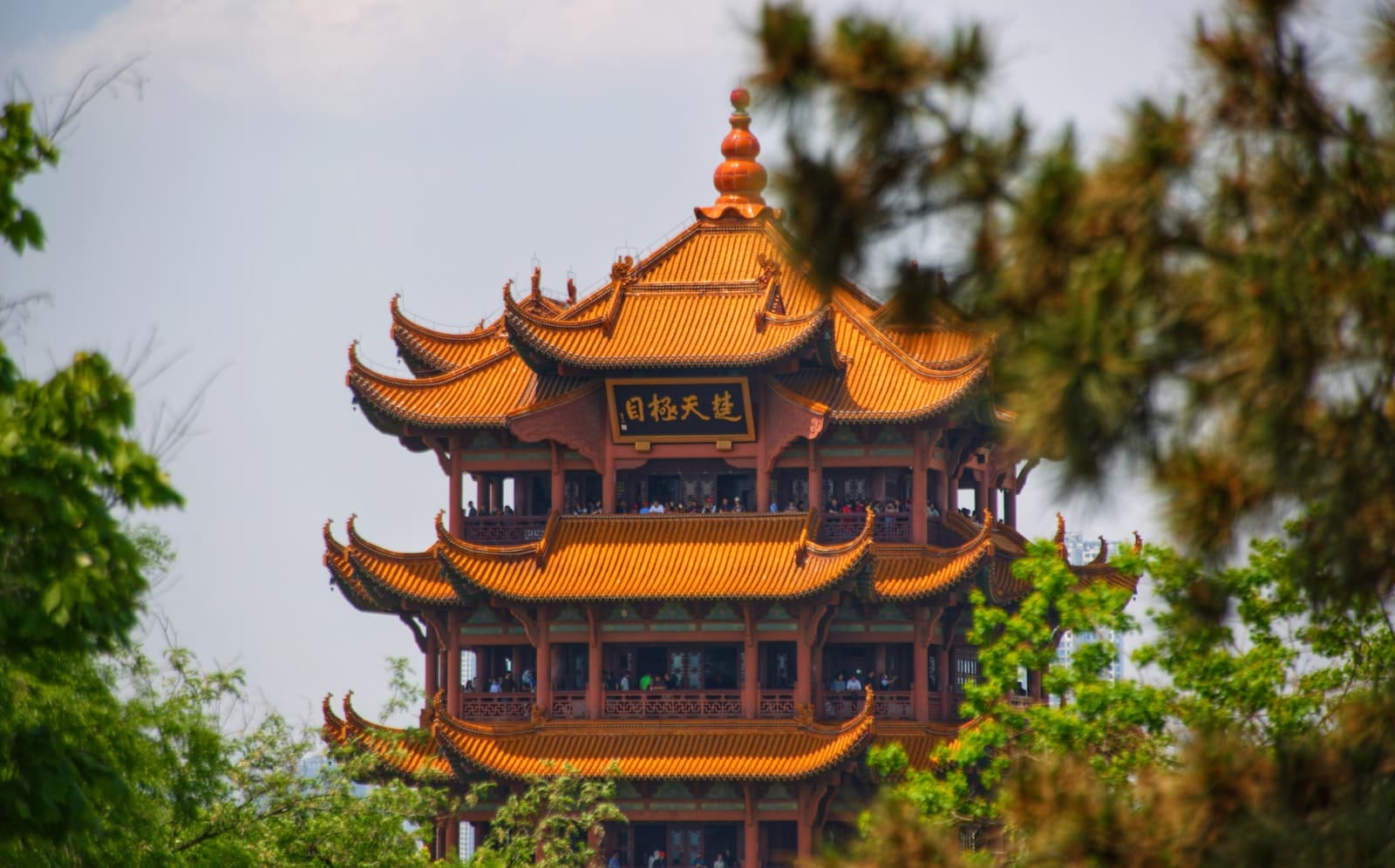 Wuhan — a tall building with a yellow roof surrounded by trees