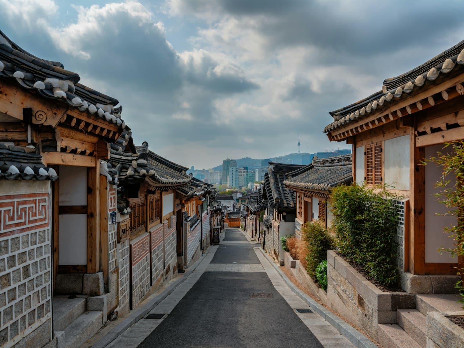 Yeosu — a street lined with wooden buildings under a cloudy sky
