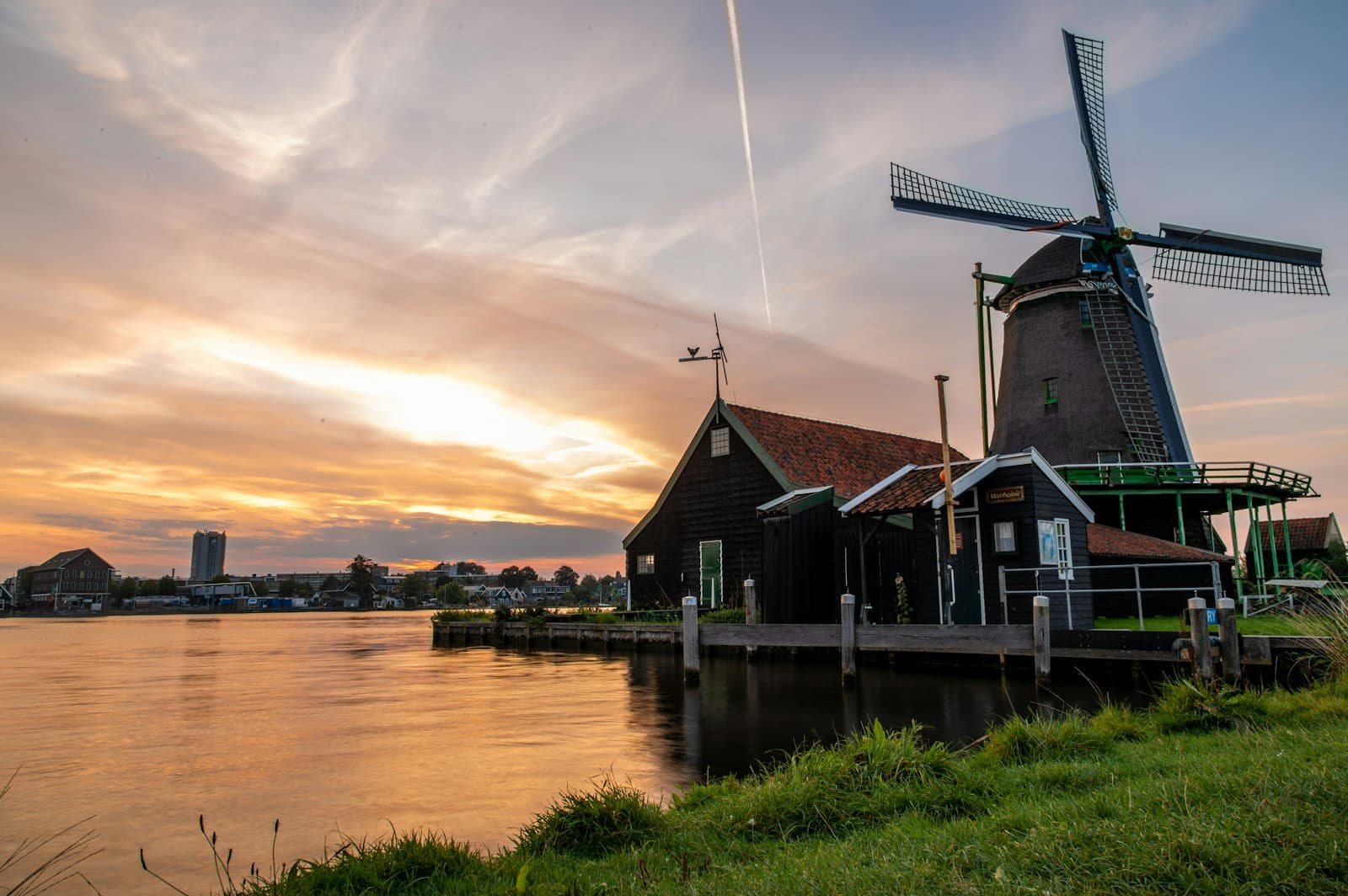 Zaandam — a windmill sitting next to a body of water