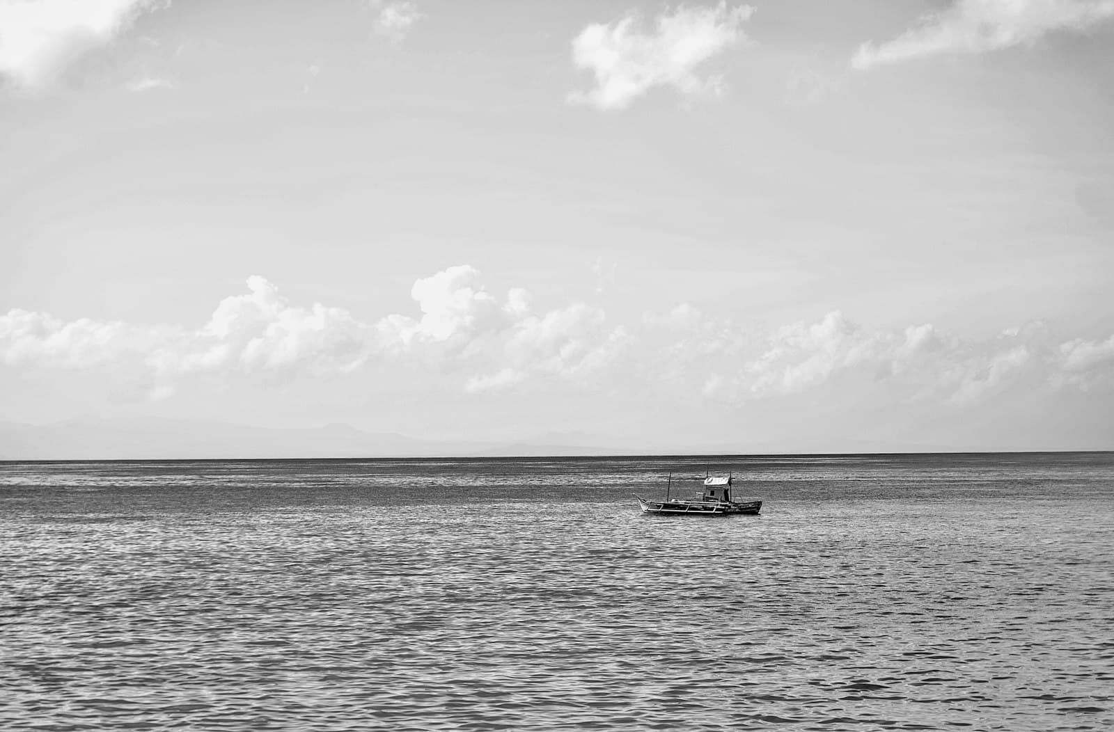 Zamboanga — a small boat floating on top of a large body of water