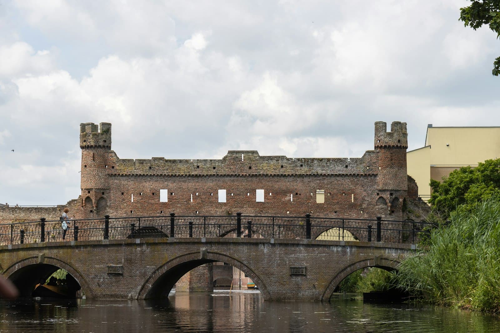 Zutphen — a bridge over a body of water with a castle in the background
