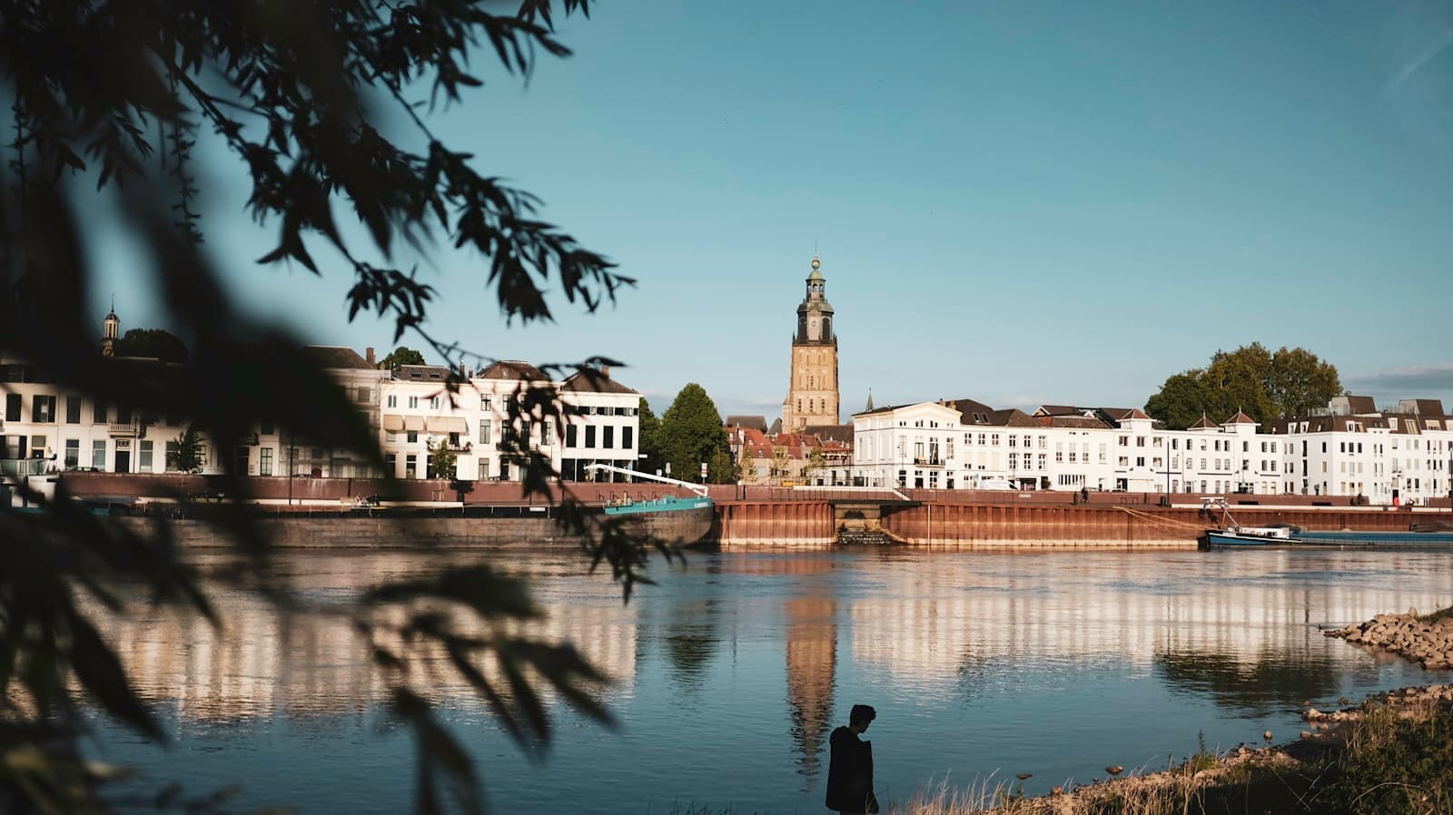 Zutphen — people walking on sidewalk near body of water during daytime
